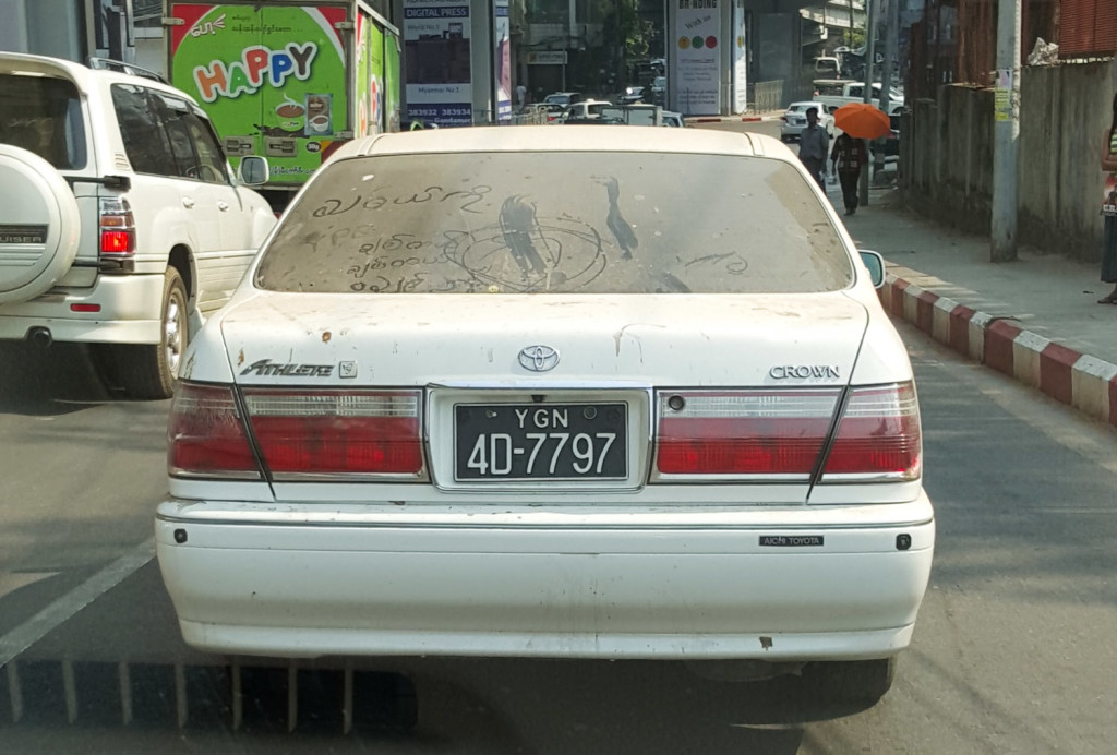 I got irrationally excited by the fact someone had written "wash me" in Burmese (I'm assuming - my reading skills don't stretch anywhere near this far) in the dirt on this car.